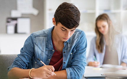 Lehrerinnen und Lehrer der Berufsschule stehend im Klassenzimmer
