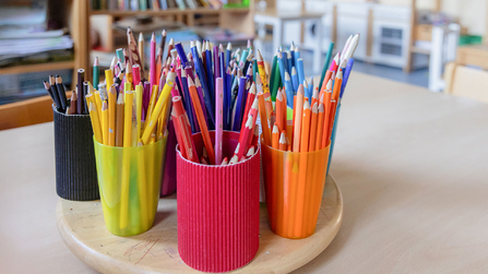 bunte Becher mit Buntstiften in der Arche Kolping
