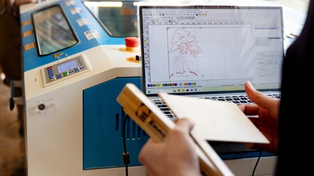 Auszubildender programmiert eine Lasermaschine