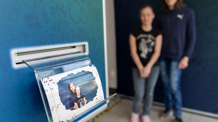 junges P&auml;rchen steht vor einer Fotobox